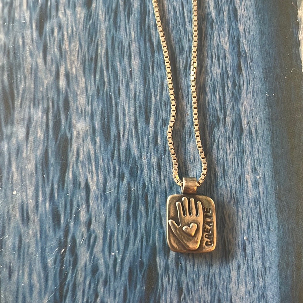 16 inch sterling silver chain and create charm by Amy Peters.